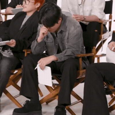 Man In Director's Chair With Paper GIF