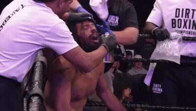 Man In Dirt Boxing Shirt Helping Man In Ring GIF