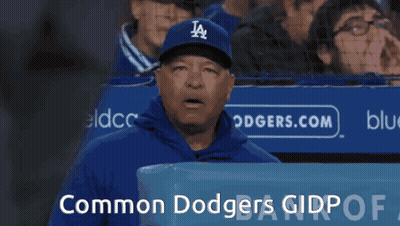 Man In Dodgers Hat In Front Of Common Dodgers Sign GIF