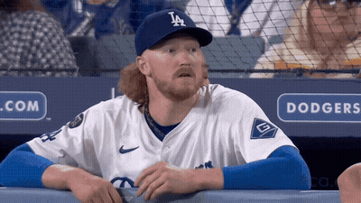 Man in Dodgers Hat Looking at Something