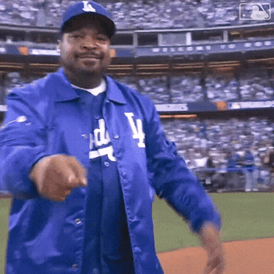Man In Dodgers Jacket And Hat Pointing GIF