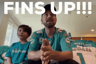 Man In Dolphins Jersey Sitting Next To Boy GIF