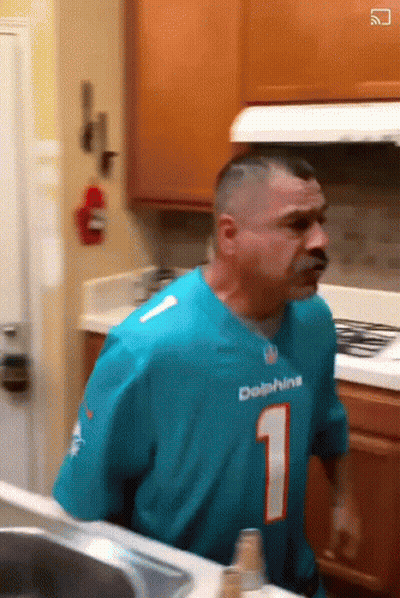 Man In Dolphins Jersey Standing In Kitchen GIF