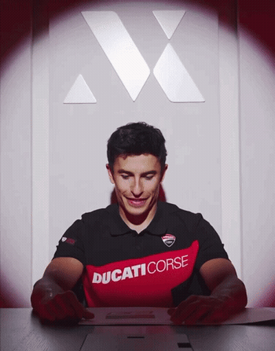 Man In Ducati Corse Shirt Looking Down GIF