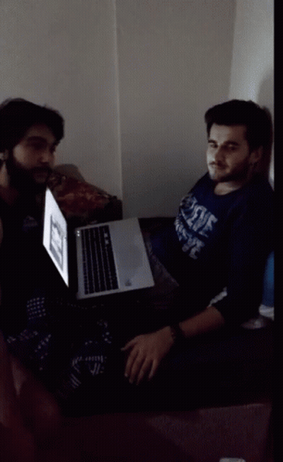 Man In Duke Shirt Sitting In Front Of Laptop GIF