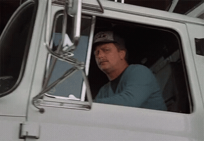 Man In Eagle Hat Driving Truck GIF