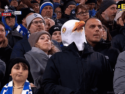 Man In Eagle Head Mask Watching Soccer Game At 39:23 GIF