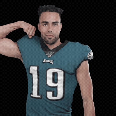 Man In Eagles Jersey Flexing Arm GIF