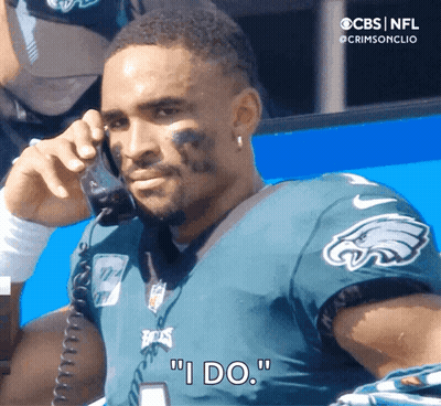 Man In Eagles Jersey Saying I Do On Phone GIF