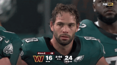 Man In Eagles Jersey Smiling In Front Of Scoreboard GIF