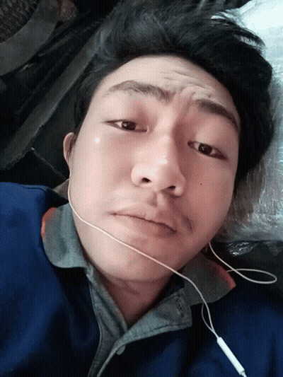 Man In Ear Buds Laying Down Looking GIF