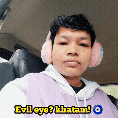 Man In Ear Muffs And Purple Shirt Saying Evil Eye GIF