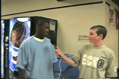 Man In Ecko Shirt Being Interviewed GIF