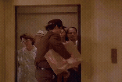 Man In Elevator Holding Box With Priority Mail Sticker GIF