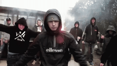 Man In Ellesse Jacket Standing In Front Of Group GIF