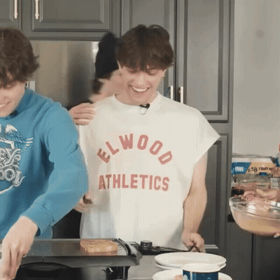 Man in Elwood Athletics Shirt Cooking