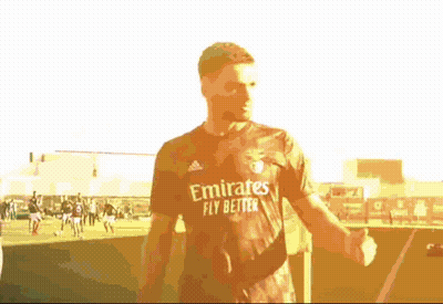 Man In Emirates Fly Better Shirt Standing On Field GIF