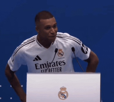 Man In Emirates Shirt Behind Podium GIF