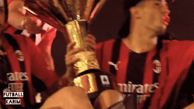 Man In Emirates Shirt Holding Trophy GIF