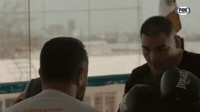 Man In Everlast Boxing Gloves Looking At Another Man GIF