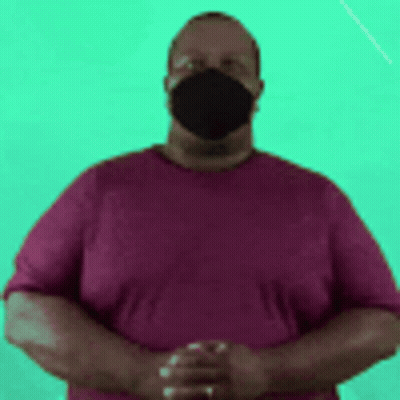 Man In Face Mask And Purple Shirt With Hands Folded GIF