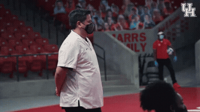 Man In Face Mask In Front Of Arrs Family Sign GIF