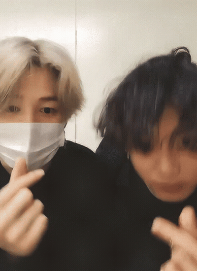Man In Face Mask Making Heart With Fingers GIF