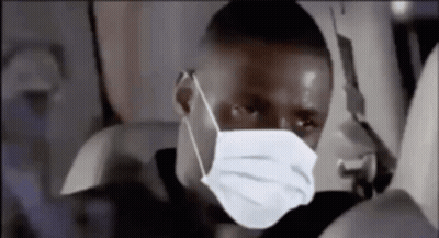 Man In Face Mask Sitting On Plane GIF