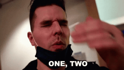 Man in Face Mask Taking Nose Swab Saying One Two