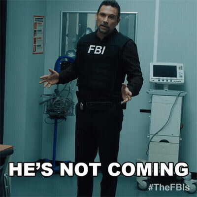 Man In FBI Vest Standing In Room GIF