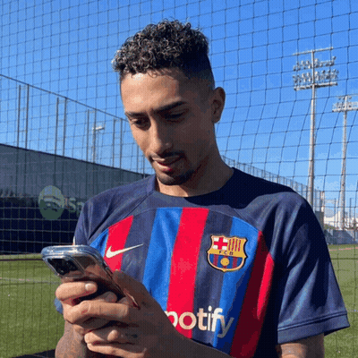 Man In FC Barcelona Shirt Looking At Phone GIF