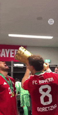 Man In FC Bayern Jersey Holding Trophy GIF
