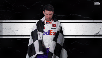 Man In FedEx Shirt Wrapped In Checkered Flag GIF