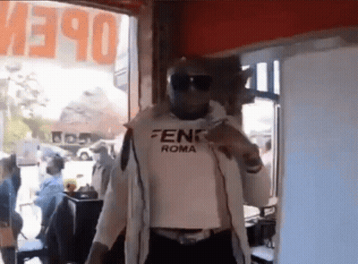 Man In Fendi Roma Shirt At Open Sign GIF