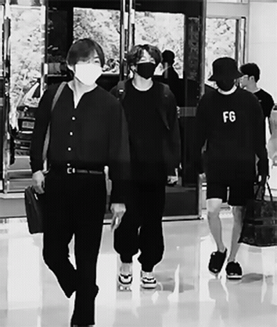 Man In FG Sweatshirt Walking With Others GIF