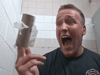 Man In Fire Dept Shirt Holding Toilet Paper GIF