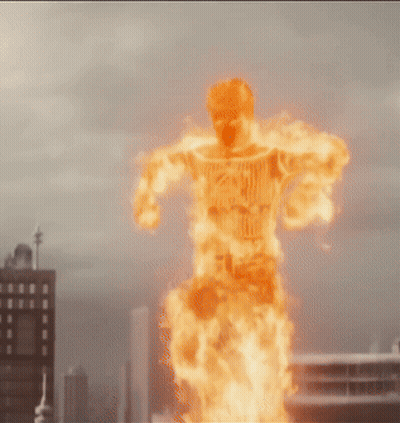 Man in Fire Suit Flying Over City Skyline