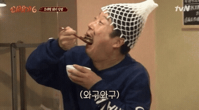 Man In Fishnet Hat Eating Food With TVN Sign GIF