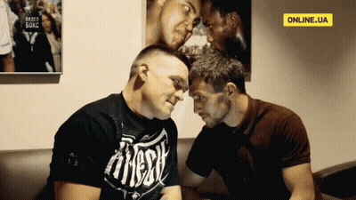 Man In Fitness Shirt Looking At Another Man GIF