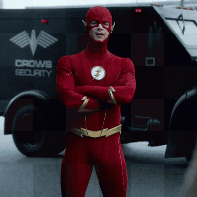 Man In Flash Costume In Front Of Crow Security Truck GIF