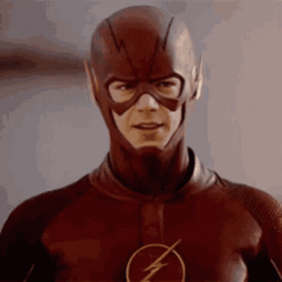 Man In Flash Costume Looking At Camera GIF