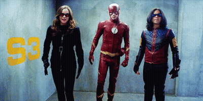 Man In Flash Costume Next To Woman And Man In Blue Jacket GIF
