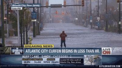 Man In Flooded Street In Front Of CNN Breaking News GIF