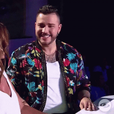 Man In Floral Jacket Beside Woman In White Tank Top GIF
