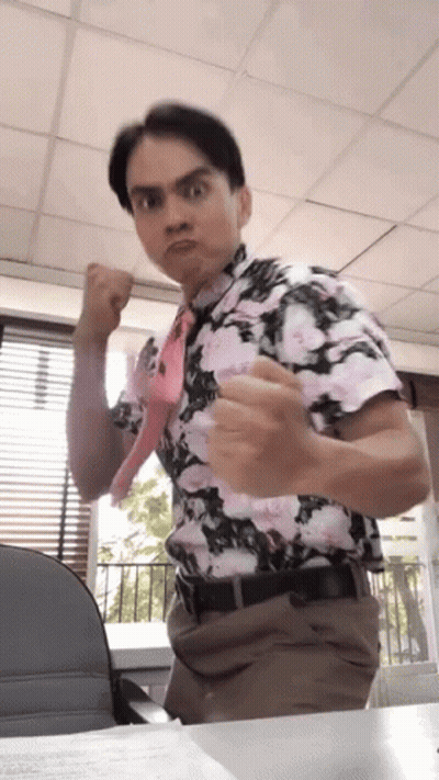 Man in Floral Shirt and Tie Making a Face