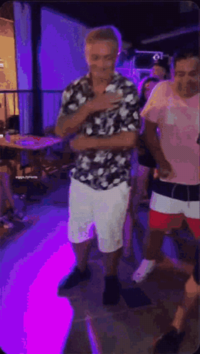 Man In Floral Shirt And White Shorts Dancing GIF