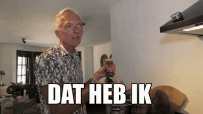 Man in Floral Shirt Holding Glass Dat Heb Ik