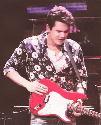 Man In Floral Shirt Holding Red Guitar GIF
