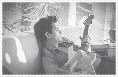 Man In Floral Shirt Holding Red Guitar GIF