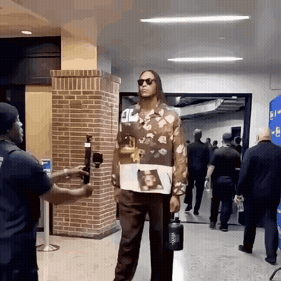 Man In Floral Shirt Holding Water Bottle GIF